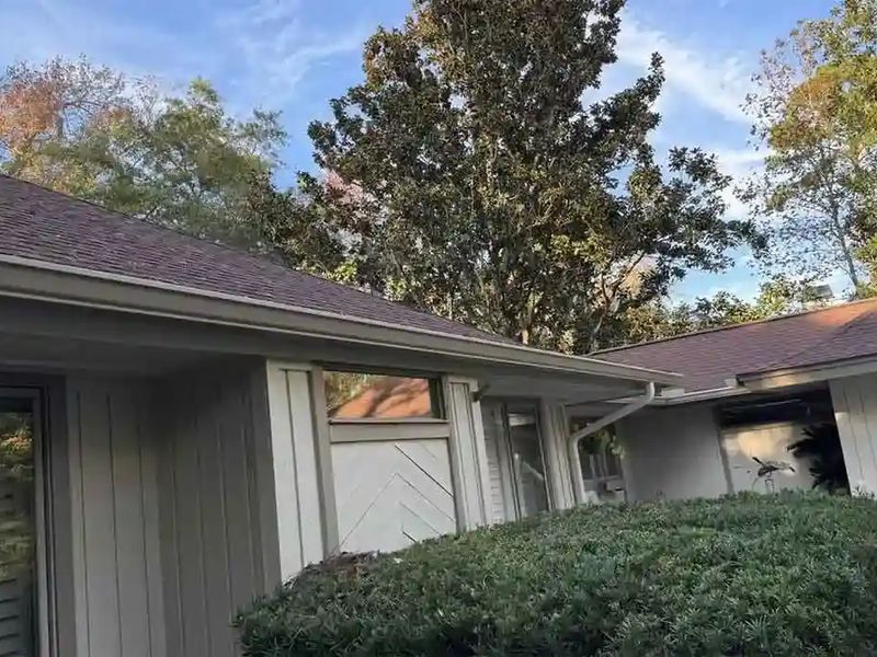 Almond gutters on the eaves of a single-story home where several roof sections meet