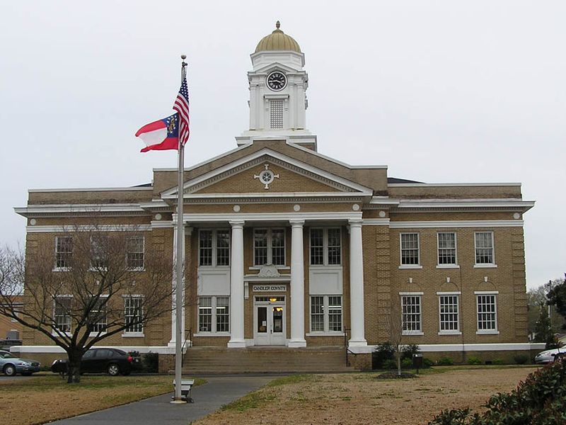 The Candler County Courthouse in Metter, Georgia, a buff-brick building with white columns and a domed clock tower