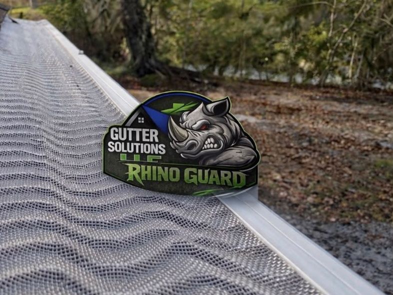 Rhino micro-mesh gutter guard fitted over a white gutter, with the Gutter Solutions LLC Rhino Guard badge
