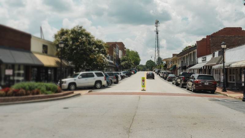 Brick storefronts and awnings lining a small-town main street in Georgia